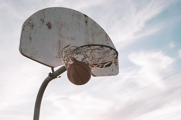 basketball hoop under cloudy sky