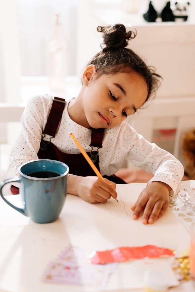 girl draws on white paper